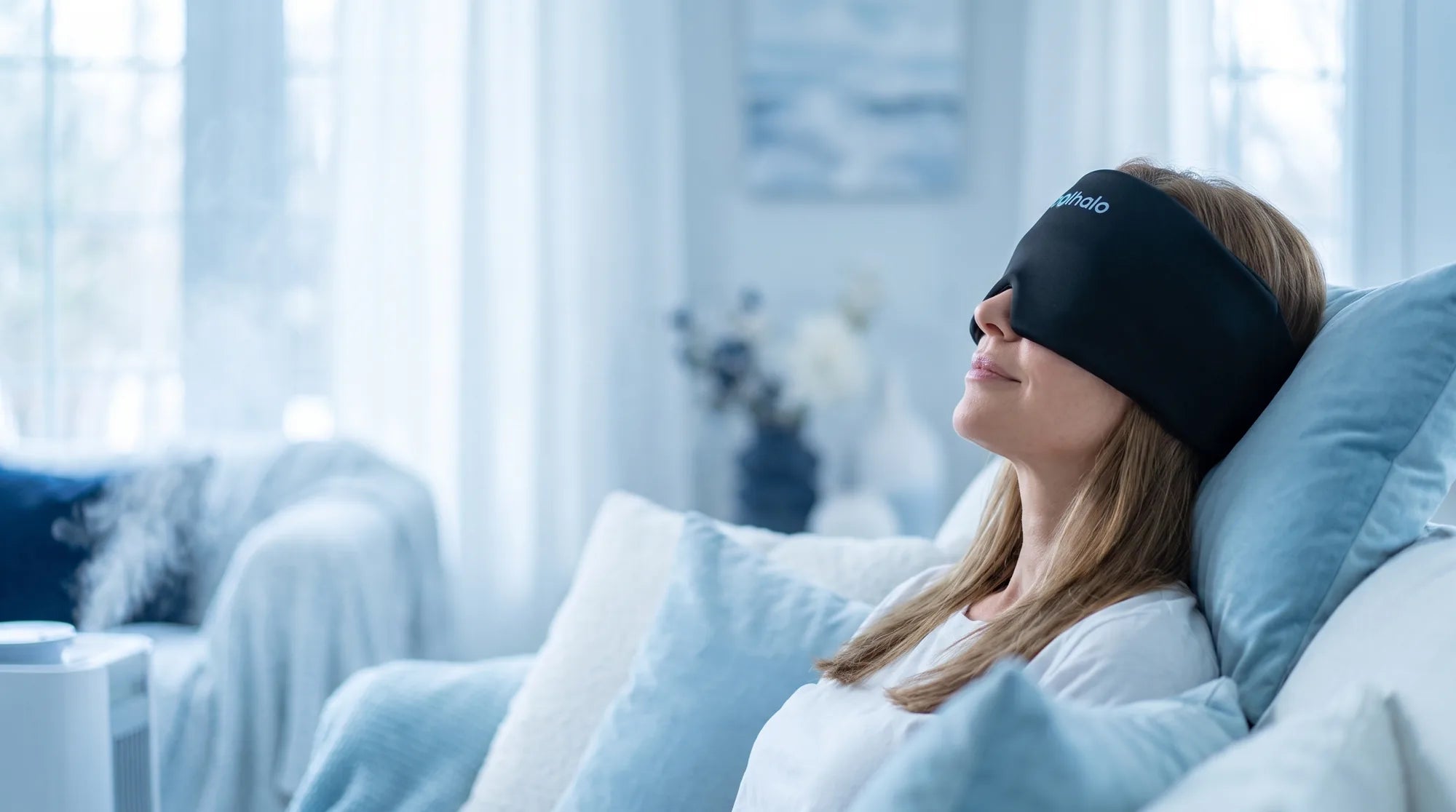 Woman relaxing with a CoolHalo 360 degree cooling head wrap