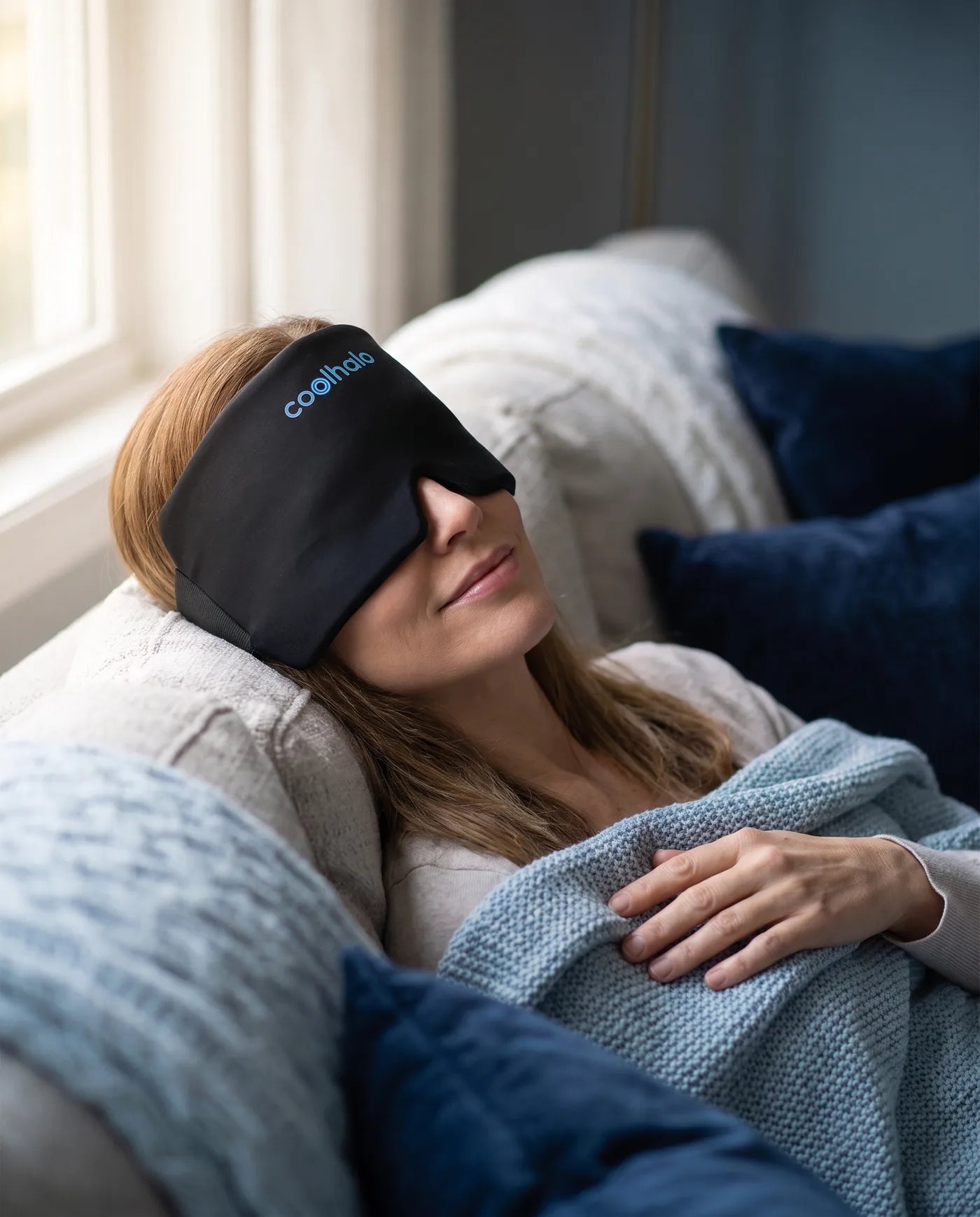 Woman resting with the CoolHalo cooling wrap over her eyes